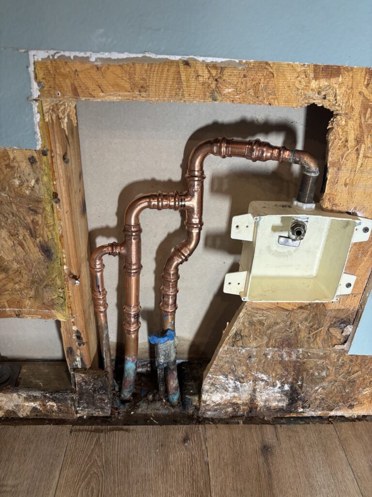 Residential plumbing valve and piping installation inside an opened wall