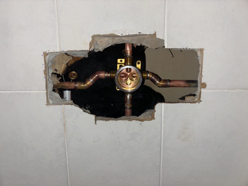 Shower valve exposed for professional plumbing repair