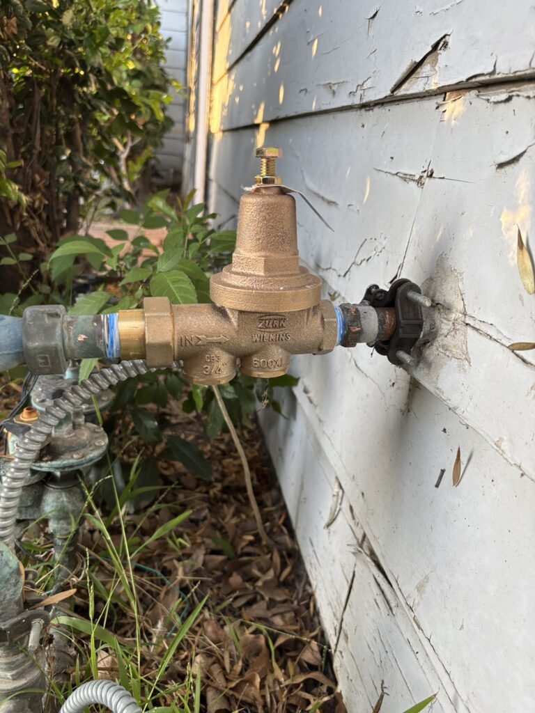Existing residential pressure regulator inspected for replacement